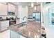 Modern kitchen with stainless steel appliances, gray cabinets, and a granite-topped island with seating at 2285 Palm Tree Dr, Kissimmee, FL 34759