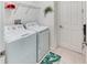 Functional laundry room featuring a washer and dryer, white tile flooring, and a modern design at 2285 Palm Tree Dr, Kissimmee, FL 34759