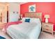 Bright main bedroom with a large bed, bedside tables with lamps, and a door to the en-suite bathroom at 2285 Palm Tree Dr, Kissimmee, FL 34759