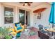 Outdoor patio with wicker chairs, a weathered wood table, and a ceiling fan for comfortable lounging at 2285 Palm Tree Dr, Kissimmee, FL 34759