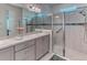 Bathroom with a glass-enclosed shower, gray cabinets, single sink, and white tile at 2285 Palm Tree Dr, Kissimmee, FL 34759