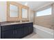 Bathroom with double vanity, neutral tile, and bathtub at 2381 Reading Trl, Kissimmee, FL 34746