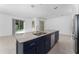 Spacious kitchen with island, stainless steel appliances, and dark cabinets at 2381 Reading Trl, Kissimmee, FL 34746