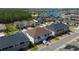 Aerial view showcasing neighborhood with lush green spaces and a lake in the background at 2449 Varenna Loop, Kissimmee, FL 34741