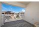 Private balcony view of a residential neighborhood with well-maintained homes and clear blue skies at 2449 Varenna Loop, Kissimmee, FL 34741