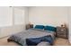 Cozy bedroom featuring a neatly made bed, two side tables, and natural light from the window at 2449 Varenna Loop, Kissimmee, FL 34741