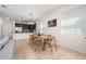 Dining area with a wooden table and chairs, adjacent to the kitchen and living room at 2449 Varenna Loop, Kissimmee, FL 34741