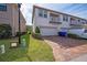 Townhouse with a brick paver driveway leading to a two-car garage and featuring an upstairs balcony at 2449 Varenna Loop, Kissimmee, FL 34741