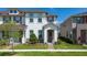 Beautiful two-story townhouse with manicured lawn and charming front entrance, creating a welcoming curb appeal at 2449 Varenna Loop, Kissimmee, FL 34741