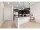 Well-designed kitchen with a breakfast bar, stainless steel appliances, and dark cabinets at 2449 Varenna Loop, Kissimmee, FL 34741