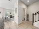 Open floor plan with tile flooring connecting the living room, entryway, and stairway at 2449 Varenna Loop, Kissimmee, FL 34741