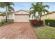 Brick paved driveway leading to a beige two-car garage at 2451 Datura Loop, St Cloud, FL 34772