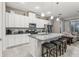 Modern kitchen with white cabinets, granite countertops and stainless steel appliances at 2451 Datura Loop, St Cloud, FL 34772