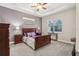Main bedroom with dark wood furniture and accent wall at 2451 Datura Loop, St Cloud, FL 34772