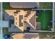An aerial view of a house with solar panels, lush green grass, a trampoline, and a well-manicured backyard at 2778 Sunkissed Dr, St Cloud, FL 34771