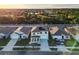 A high aerial view showcases a home with solar panels, green shutters, and a manicured front yard at 2778 Sunkissed Dr, St Cloud, FL 34771