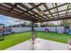 Covered patio with hanging chair and artificial turf at 2778 Sunkissed Dr, St Cloud, FL 34771