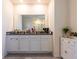Double vanity bathroom with granite countertop and white cabinets at 2778 Sunkissed Dr, St Cloud, FL 34771