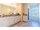 Double vanity bathroom with granite countertop and white cabinets at 2778 Sunkissed Dr, St Cloud, FL 34771