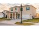 Beautifully designed two-story home featuring a manicured lawn, a covered front porch, and a spacious two-car garage at 2778 Sunkissed Dr, St Cloud, FL 34771