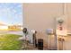 Exterior view of utilities with water filtration system, electric meter, and hose on stucco wall at 2778 Sunkissed Dr, St Cloud, FL 34771