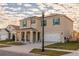 Beautiful two-story home with a covered porch, green shutters, and well-manicured landscaping at 2778 Sunkissed Dr, St Cloud, FL 34771