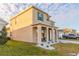 Charming two-story home featuring a covered porch, green shutters, and well-kept lawn at 2778 Sunkissed Dr, St Cloud, FL 34771