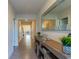 Stylish hallway with decorative mirror and console table with elegant decor and tile floors at 2778 Sunkissed Dr, St Cloud, FL 34771