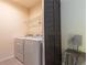 Laundry room with washer, dryer, and ample shelving at 2778 Sunkissed Dr, St Cloud, FL 34771