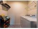 Bright laundry room with washer, dryer, and shelving at 2778 Sunkissed Dr, St Cloud, FL 34771