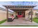 Inviting outdoor patio with stylish furniture, a pergola, and a comfortable seating arrangement at 2778 Sunkissed Dr, St Cloud, FL 34771
