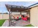 Outdoor patio featuring pergola, lounge seating, BBQ, and hammock for backyard relaxation at 2778 Sunkissed Dr, St Cloud, FL 34771