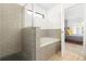 Beautiful bathroom with a tiled shower, soaking tub, and adjacent bedroom access at 2818 Roccella Ct, Kissimmee, FL 34747