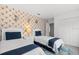 Stylized bedroom featuring two twin beds with vibrant wallpaper and bright lighting at 2818 Roccella Ct, Kissimmee, FL 34747