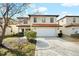 Inviting two-story home featuring a two-car garage, landscaped front yard, and a classic tile roof at 2818 Roccella Ct, Kissimmee, FL 34747