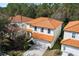 Aerial view of a two-story home featuring a classic tile roof and lush surrounding trees at 2818 Roccella Ct, Kissimmee, FL 34747