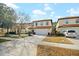 Exterior view of a well-kept two-story home with a two-car garage and landscaped front yard at 2818 Roccella Ct, Kissimmee, FL 34747