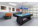 Finished game room features a pool table, foosball table and custom decorative wall art at 2818 Roccella Ct, Kissimmee, FL 34747