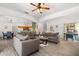 Bright and airy living room with an open floor plan, wood floors, and contemporary furnishings at 2818 Roccella Ct, Kissimmee, FL 34747