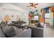 Living room boasts gray sofas, decorative wall art and a television for entertaining guests at 2818 Roccella Ct, Kissimmee, FL 34747