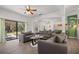 Spacious living room features modern decor, wood floors, and sliding doors to the outdoor pool area at 2818 Roccella Ct, Kissimmee, FL 34747