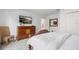 Bright main bedroom with a wooden dresser, TV, and a door to the adjoining en-suite bathroom at 2818 Roccella Ct, Kissimmee, FL 34747