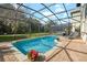 Sparkling in-ground screened-in pool offers a perfect outdoor retreat with patio and greenery at 2818 Roccella Ct, Kissimmee, FL 34747