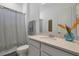 Bathroom with gray shower curtain, white vanity, and quartz countertop at 3055 Prospect Trl, St Cloud, FL 34771