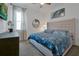 Main bedroom with king bed, blue bedding, and window with curtains at 3055 Prospect Trl, St Cloud, FL 34771