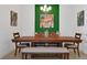 Dining room with wood table, bench seating, and an accent wall at 3055 Prospect Trl, St Cloud, FL 34771