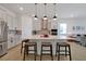 Modern kitchen that opens to the living area, featuring an island and stainless steel appliances at 3055 Prospect Trl, St Cloud, FL 34771
