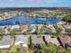 Birds-eye view of homes around a lake at 327 Davinci Pass, Kissimmee, FL 34759