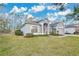 Gray house with American flag, two-car garage, and manicured lawn at 3623 Hawkshead Dr, Clermont, FL 34711