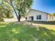 Spacious backyard with a mature tree providing shade and a white fence surrounding the property at 438 Jay Ct, Kissimmee, FL 34759